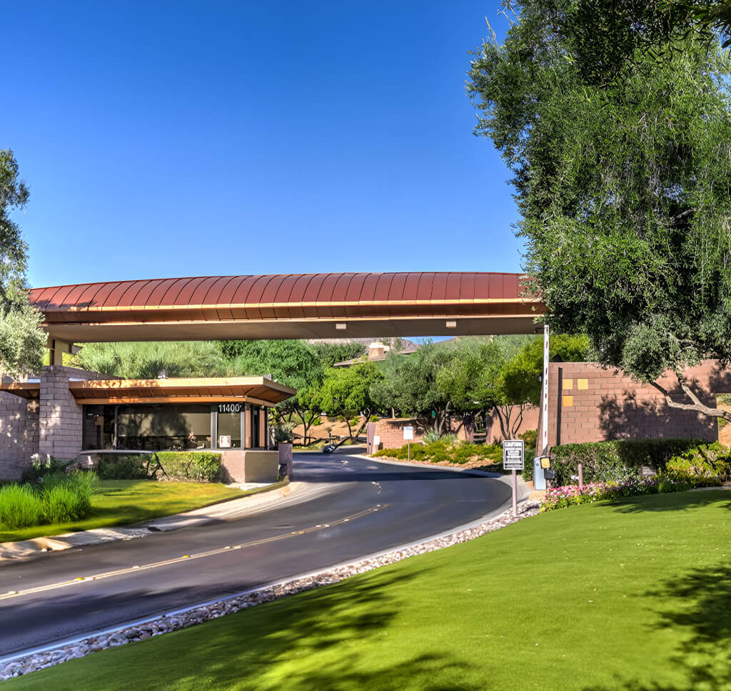 An entrance, highlighting its inviting design and the lush environment that surrounds it.